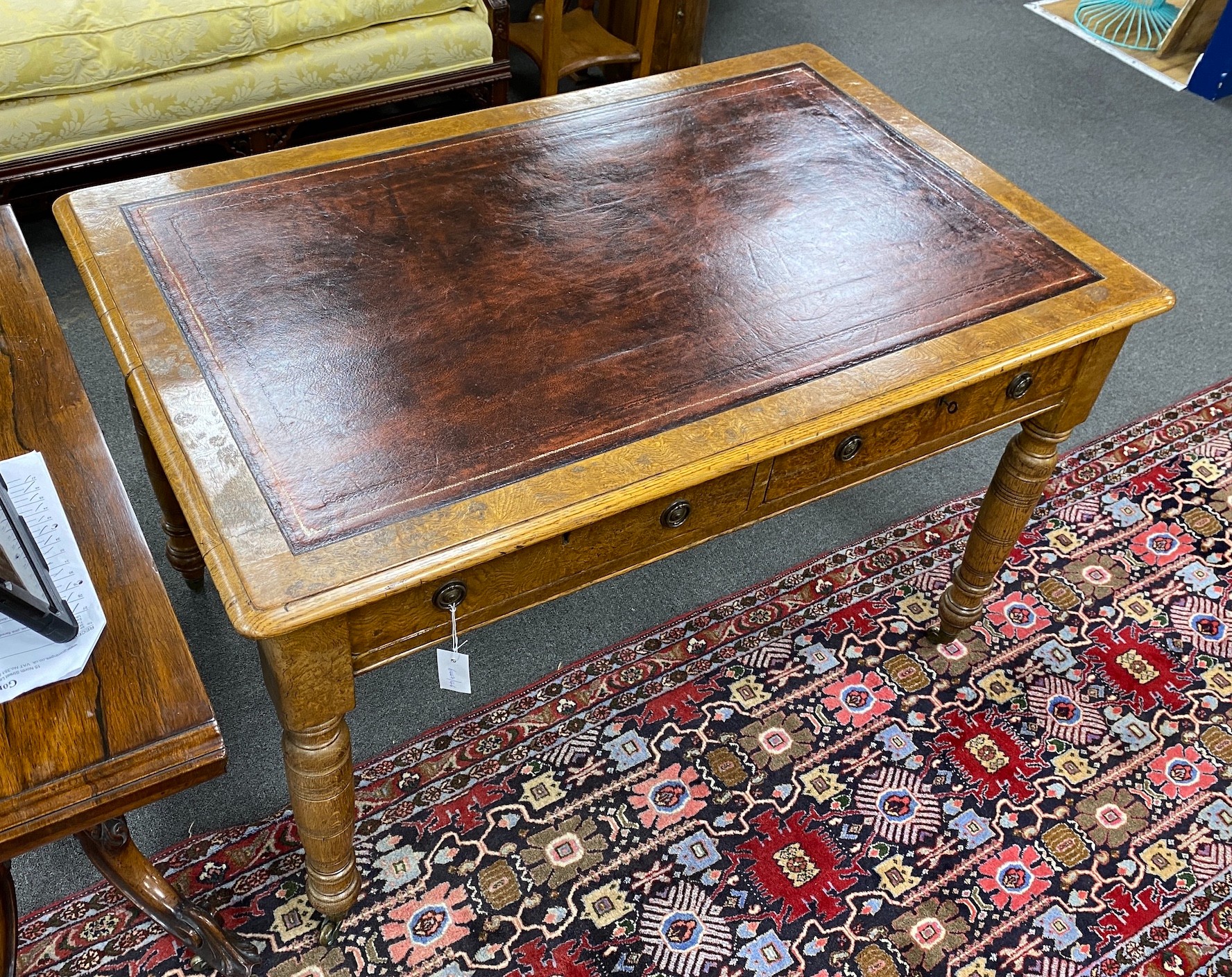 A Victorian oak and pollard oak writing table fitted two drawers opposed by dummy drawers width 120cm, depth 78cm, height 76cm.